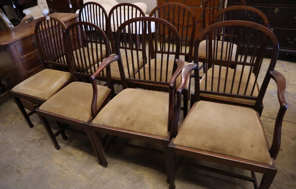 A set of nine Edwardian Hepplewhite white style mahogany dining chairs, including two carvers, with reeded backs and drop in seats, on